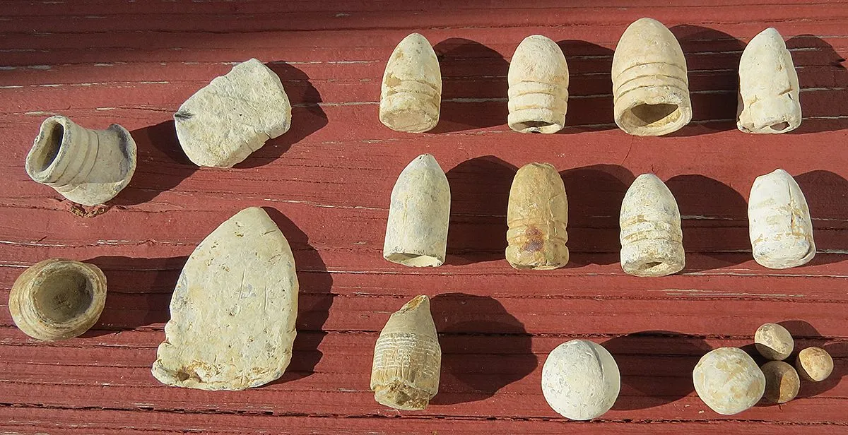 A few of the different types of bullets including two poker chips.