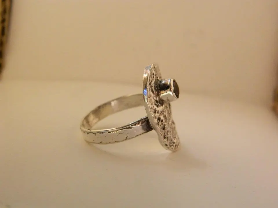 Another side view of abstract sterling silver and garnet ring