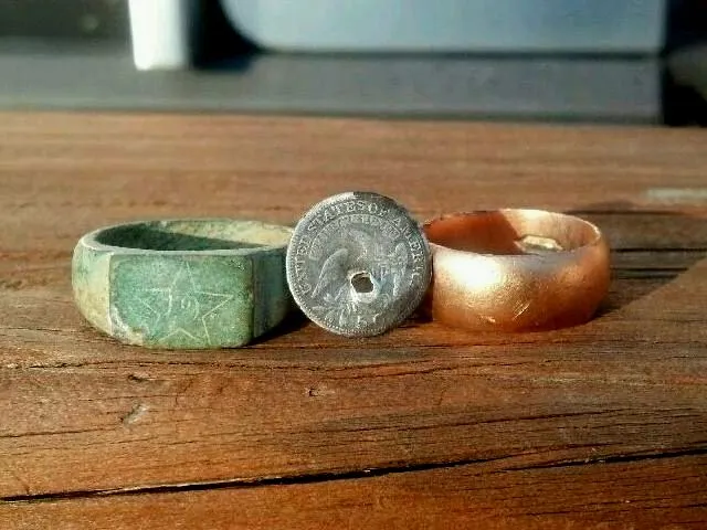 Brass regimental ring, gold ring, and 1820 half dime found in one day.
