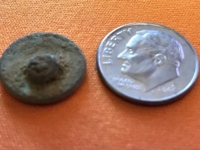 Button #2. Small. Shank side. Found with the XP DEUS on the other side of the James River. Could be colonial. Will post in forums for for ID. Smooth s