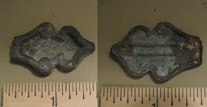 Chunk o' crucifix - You tell me.  I think it's a piece of the not-so-true cross, cast brass.  Found in a park in Merriam, KS in spring 2009.