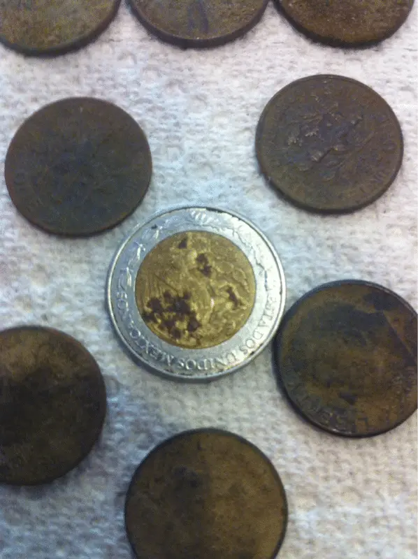 First Peso in a pocket spill of dimes.