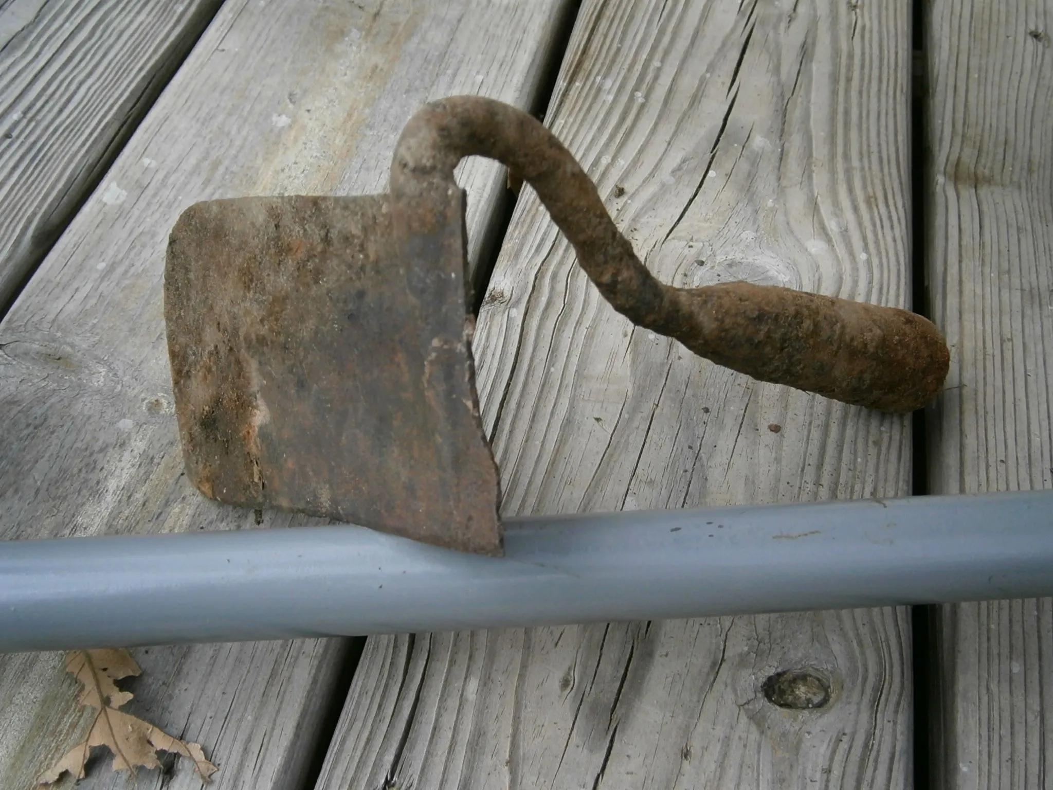 half a garden hoe, well worn and filed blade concave