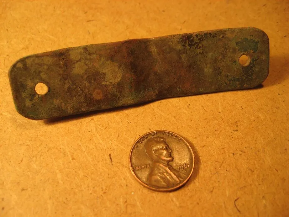 Hand-stamped brass tag found on former farm site in eastern KS (back).