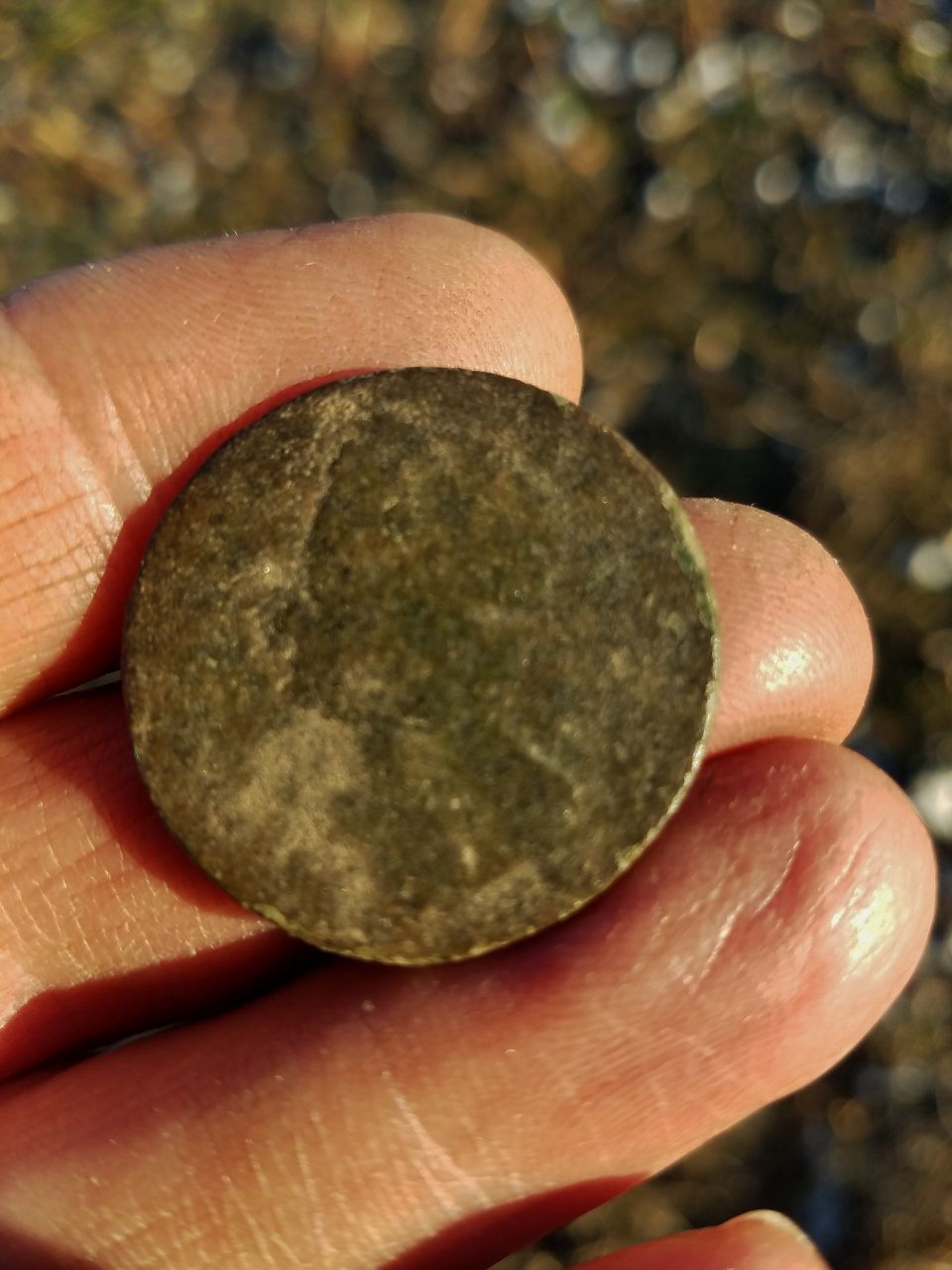 King George II half penny.  The date is worn off but it has the "old head" bust which puts it in the range of 1740-1754.
