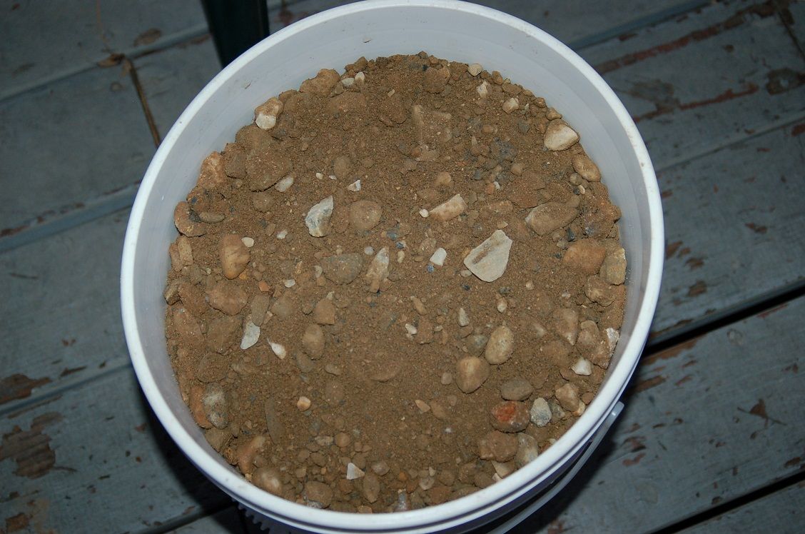 One five gallon bucket of unwashed coarse sand and rock purchased from Hansen Bros in Grass Valley