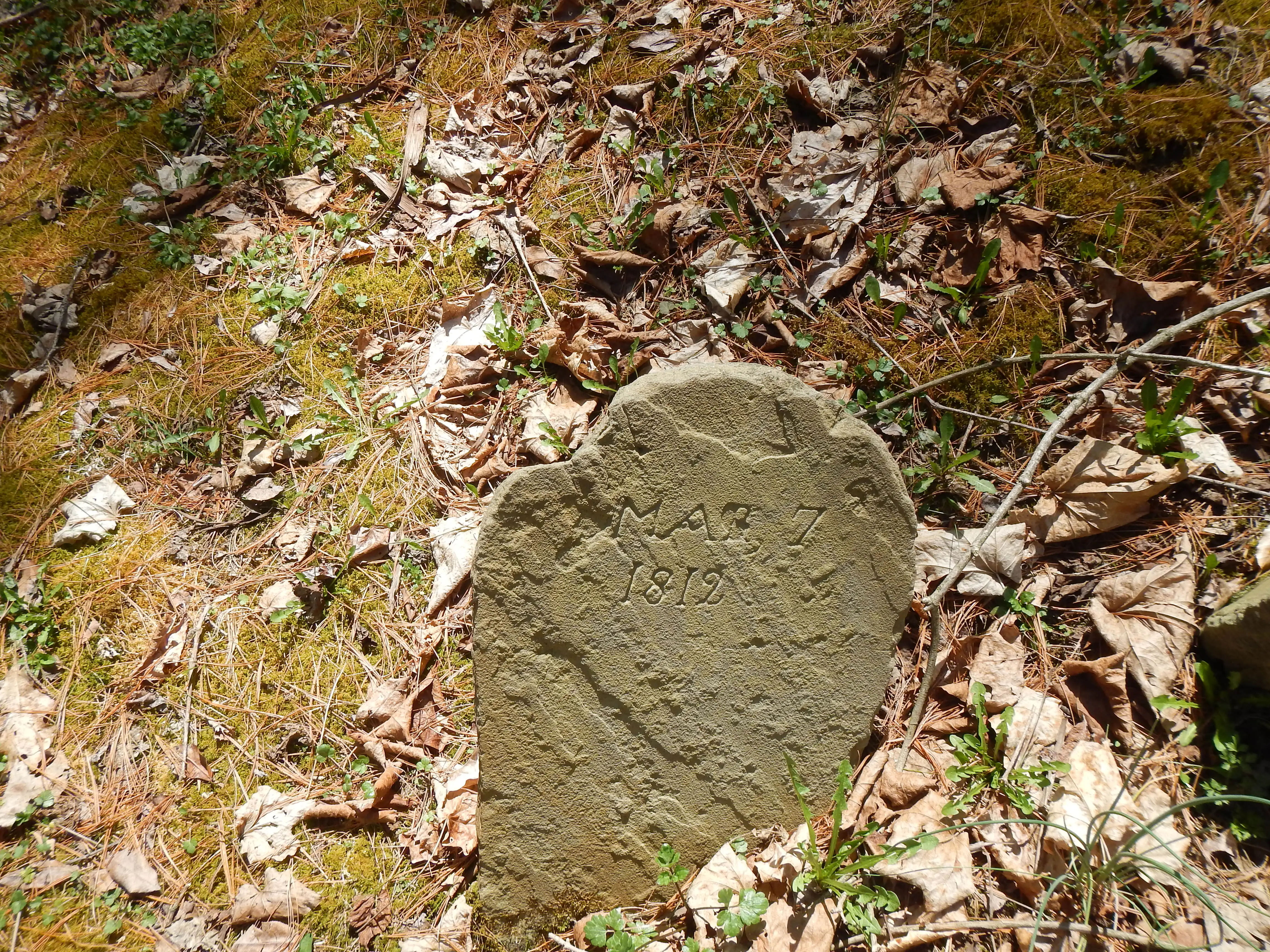 Original worn sandstone foot stone.