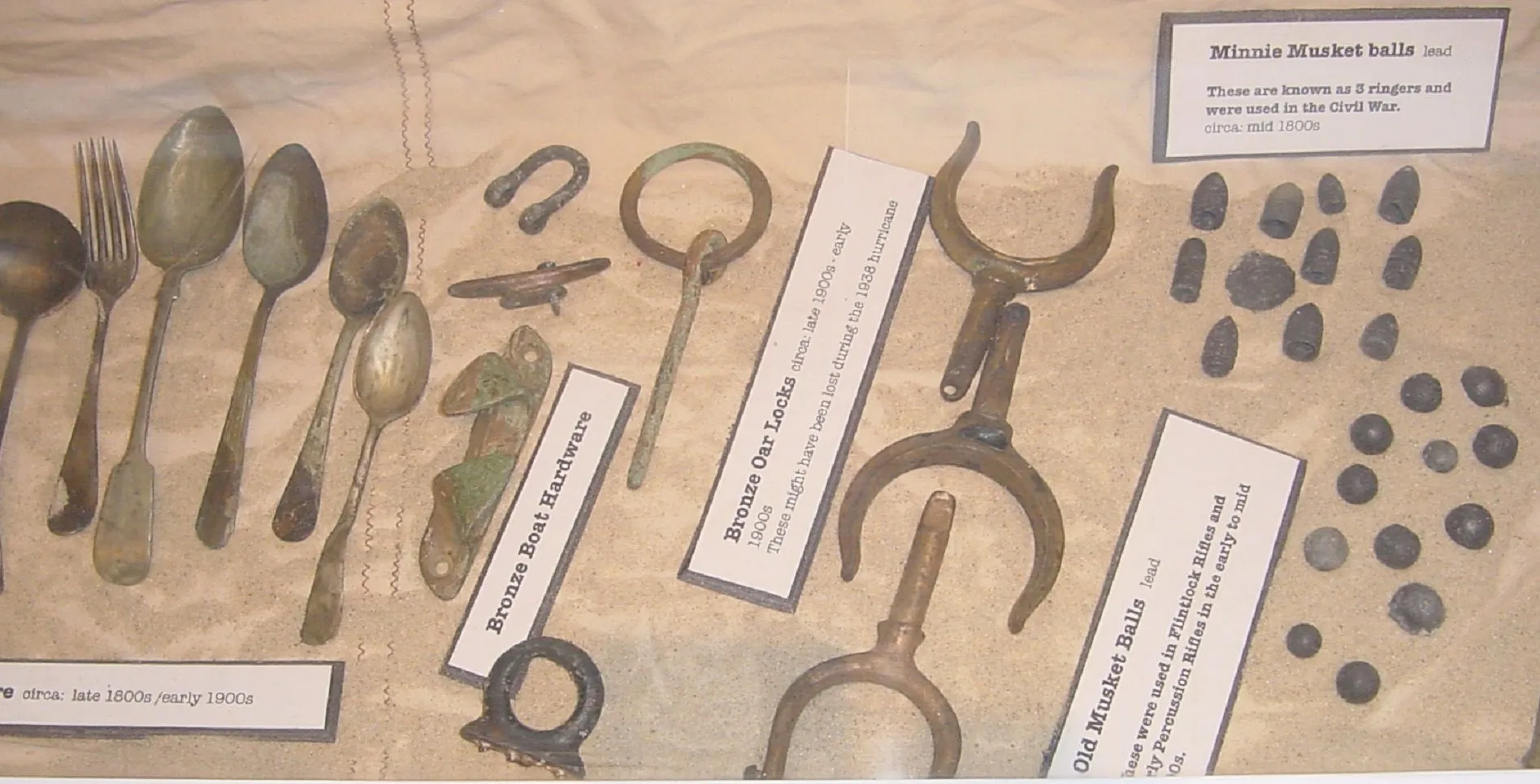 PART OF DISPLAY I PUT ON LOAN
THIS INCLUDES FLATWARE - BOAT PARTS - OLD OAR LOCKS - MINIE BALLS CIRCA MID 1800S - AND MUSKET BALLS - EARLY 1800S