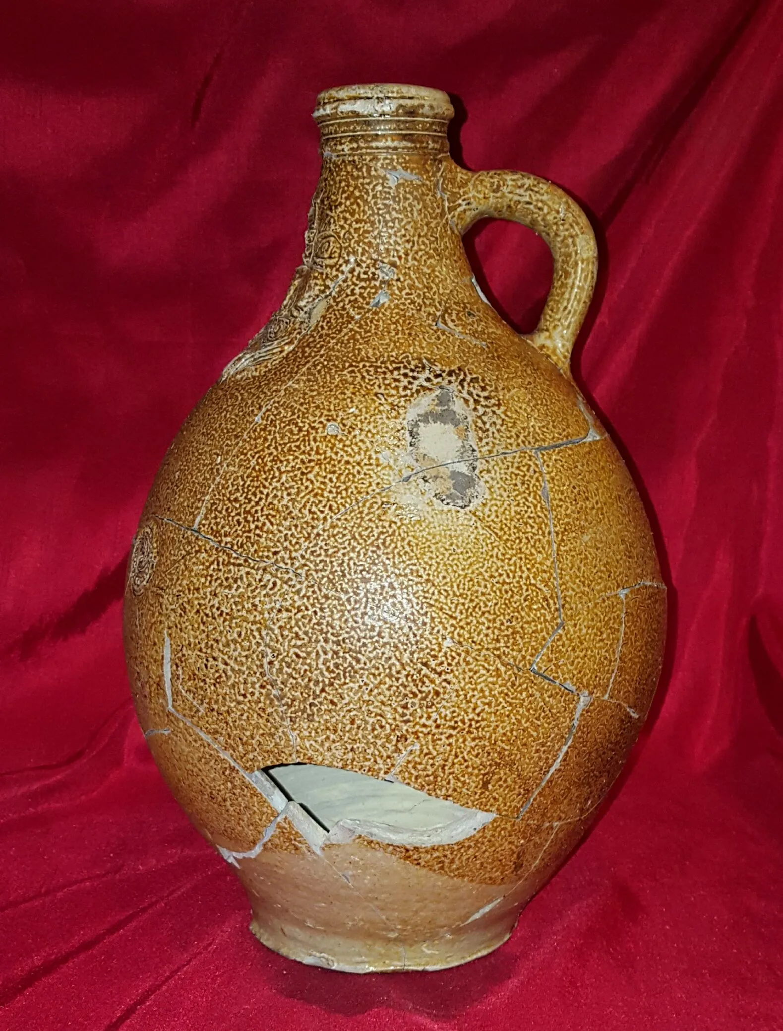 Reconstructed 17th century Bellarmine (aka Bartmann) jug. Shards dug from the "Swamp Pit"