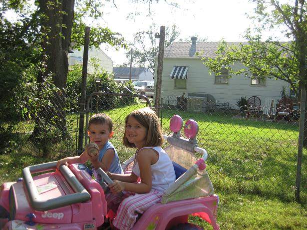 Samantha and Bryce navigating the yard in the barbie jeep