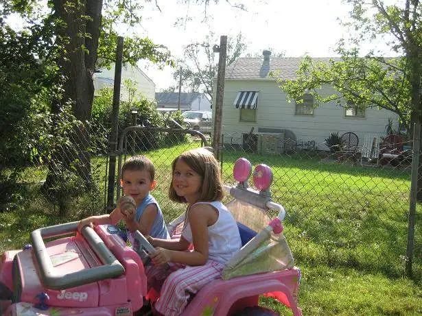 Samantha and Bryce navigating the yard in the barbie jeep