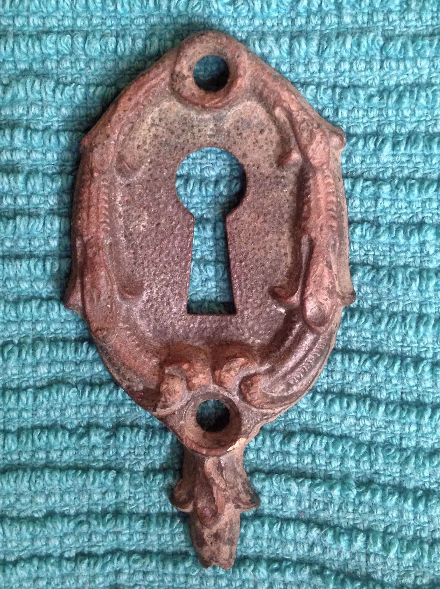 Skeleton key plate from early 1900's found in a parking lot of an old building downtown.