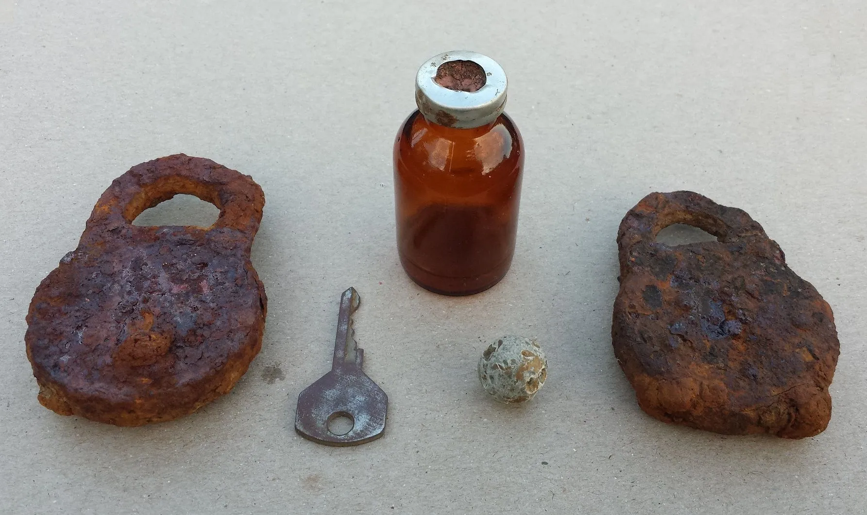 Some relics found where a Civil War Confederate hospital used to be. Included are 2 old locks, a key, an old syringe bottle and a round ball. Alll fou