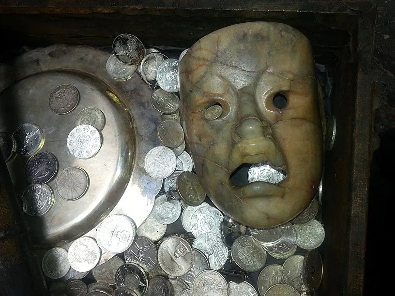 The treasure chest was filled with many silver coins.