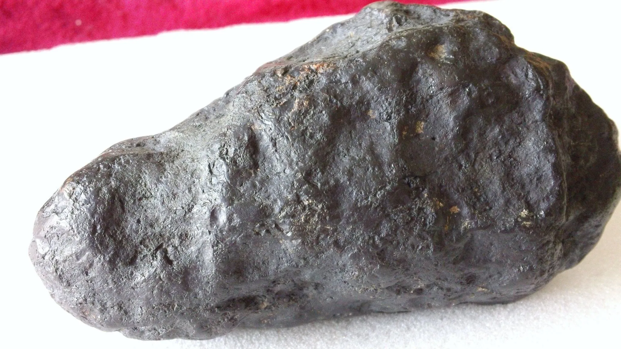 This particular stone weighed in at 1038 grams, slightly magnetic, has a "thumbprint" a shiny exterior, and a fire line on one side. I've been told th