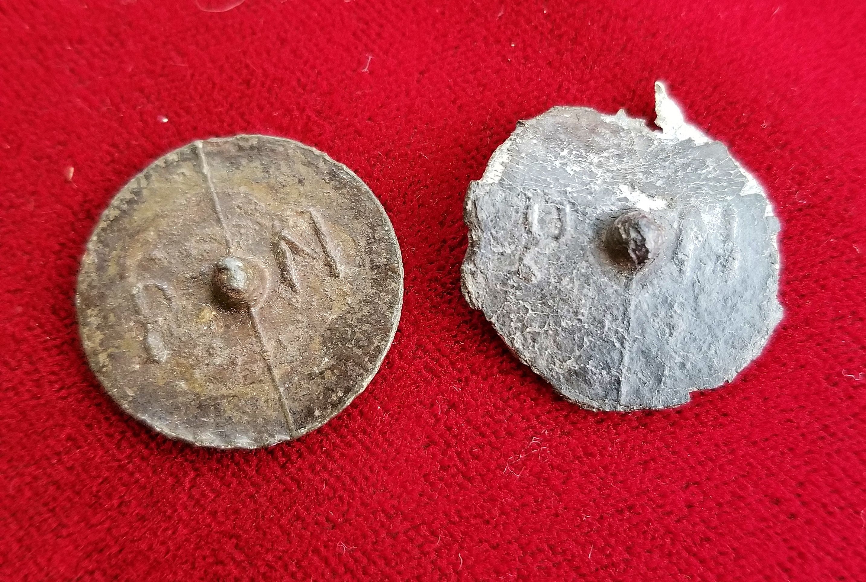 Two pewter coat buttons with raised letters "PN" on the back.  These were likely worn by American troops during the Revolutionary War.