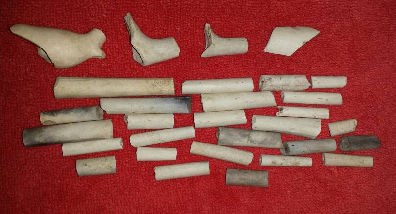 Various kaolin pipe stem and bowl fragments