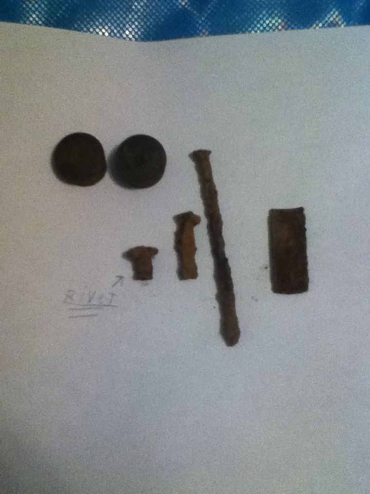 Well one is a nail and there is a rivet. The other two round things are from shotgun shells